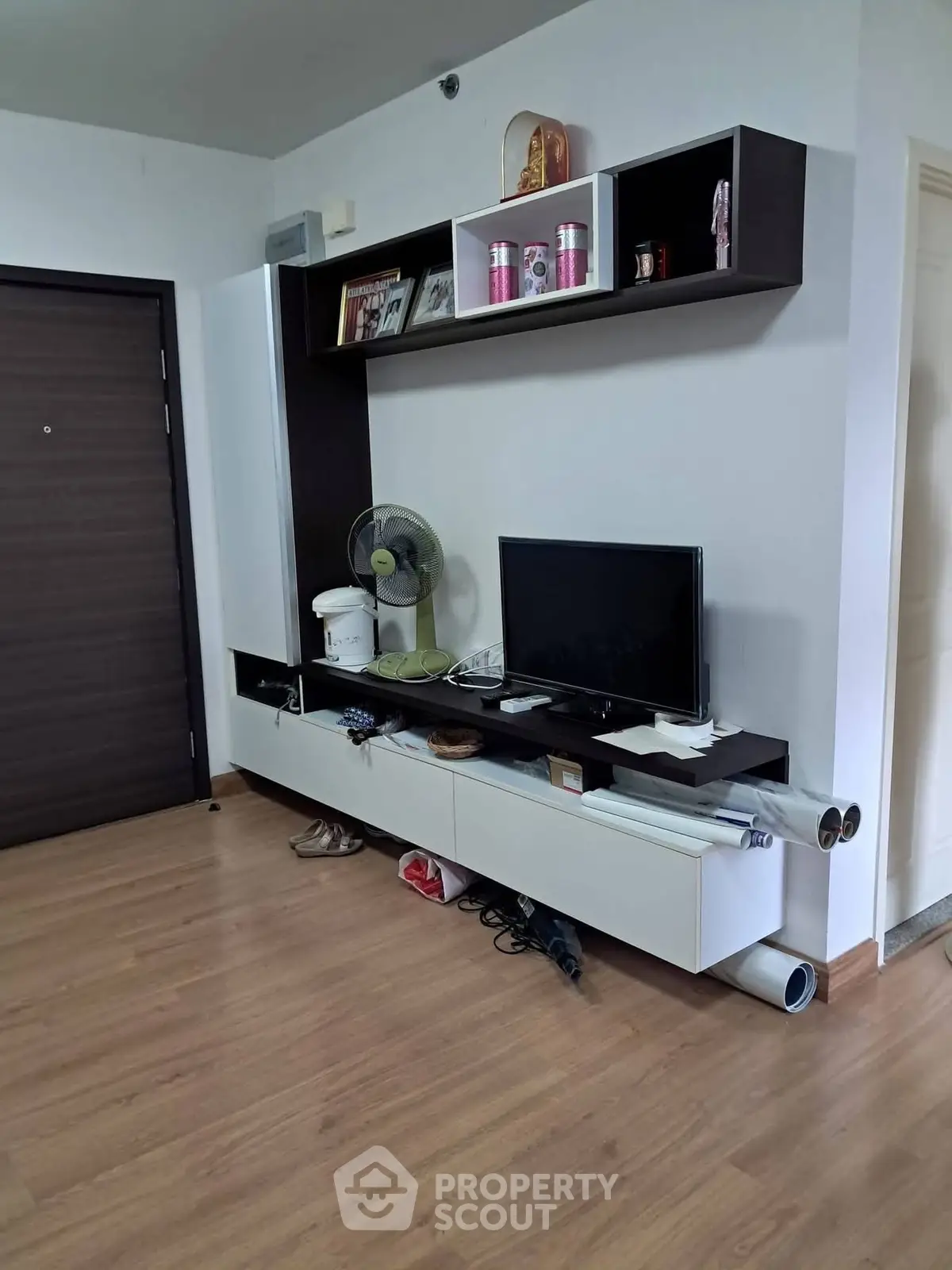 Modern living room with sleek TV unit and wooden flooring