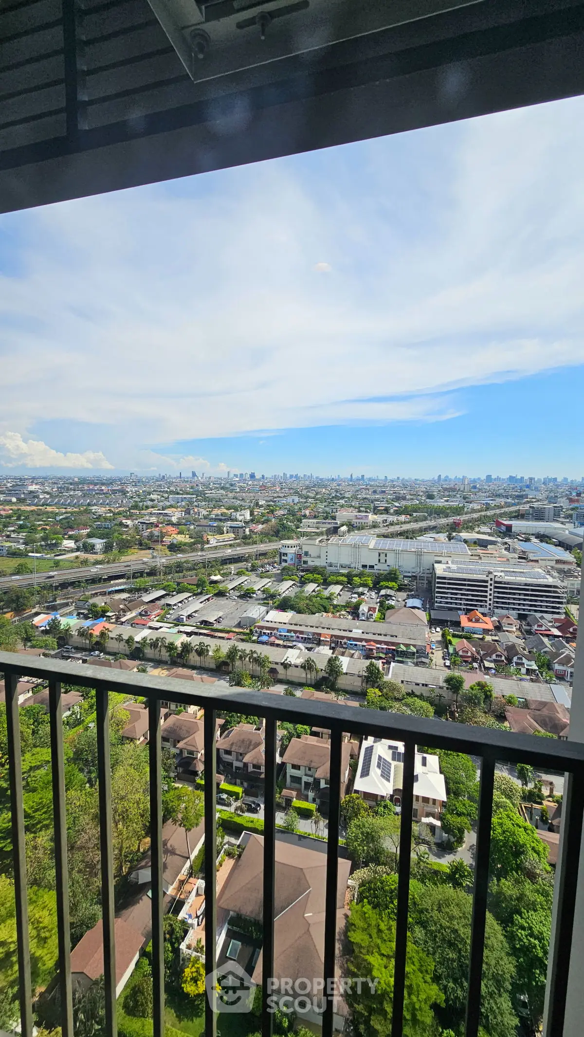 Stunning cityscape view from high-rise balcony, perfect for urban living enthusiasts.