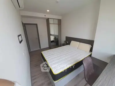 Modern bedroom with stylish furniture and natural light, perfect for comfortable living.