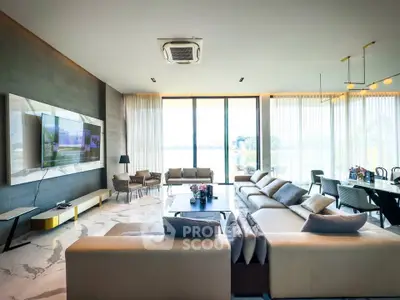 Luxurious modern living room with large windows and elegant furnishings, offering a stunning view.