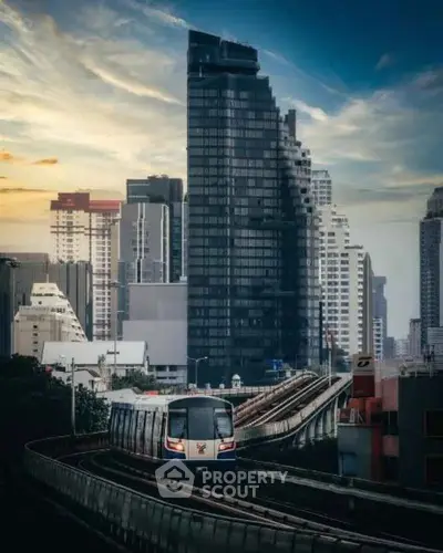 Stunning urban skyline with modern high-rise buildings and a train on elevated tracks at sunset.