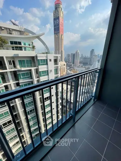Stunning city view from modern high-rise balcony with sleek railing.