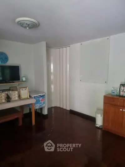 Cozy interior room with wooden flooring and modern furnishings, ideal for a comfortable living space.