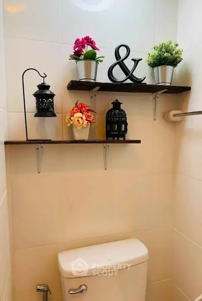 Charming bathroom with decorative shelves and modern fixtures, perfect for cozy living spaces.