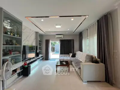 Spacious modern living room with large windows and elegant decor