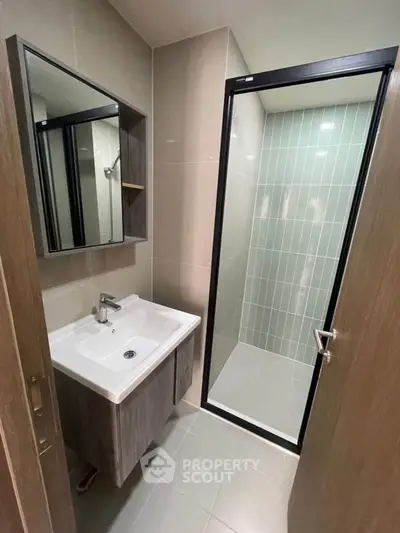Modern bathroom with sleek design featuring a glass shower enclosure and stylish vanity.