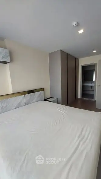 Modern bedroom with sleek design and ample storage space.