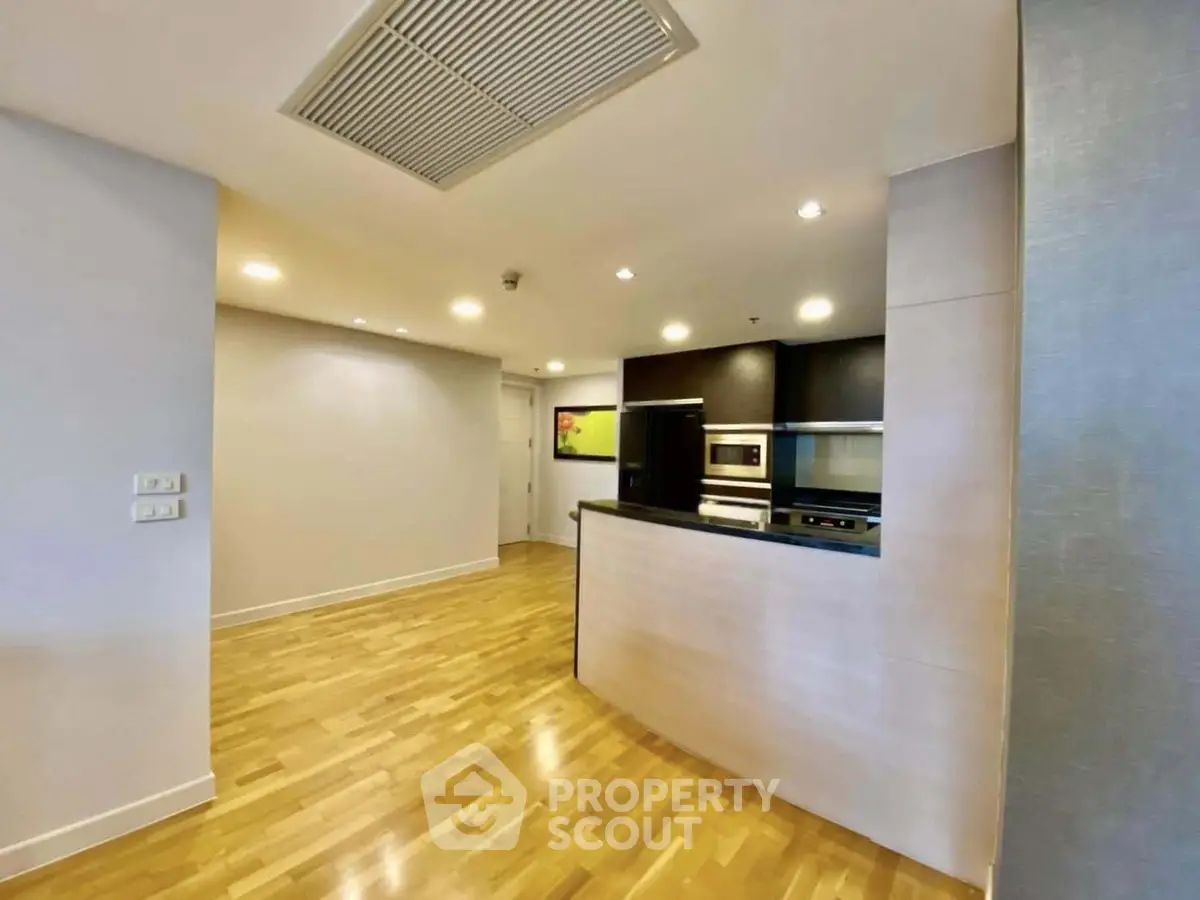 Modern kitchen with open layout and sleek appliances in a stylish apartment.