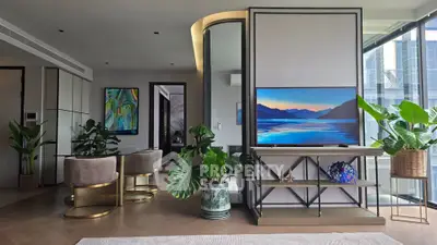 Luxurious modern living room with elegant decor and large windows offering natural light.