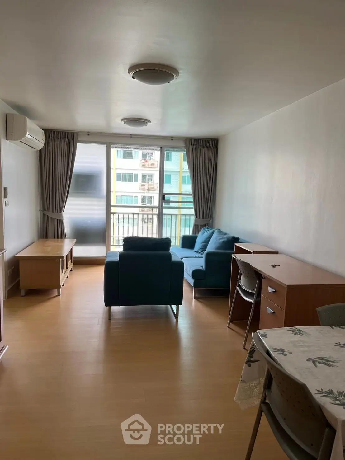 Spacious living room with modern furniture and large window offering natural light.