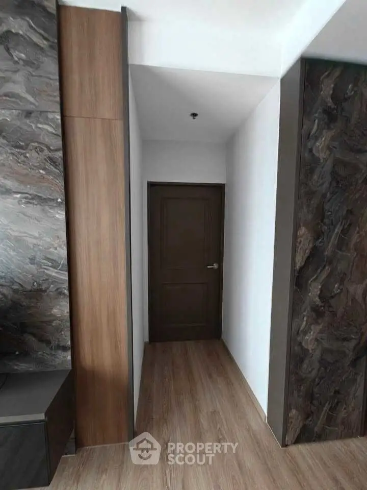 Modern hallway with wooden flooring and sleek door design