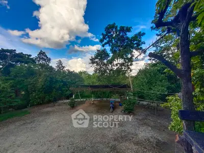 Expansive outdoor area with lush greenery and open sky, perfect for nature lovers.