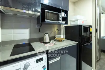 Modern kitchen with sleek appliances and compact design