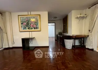 Spacious living room with elegant wooden flooring and stylish decor