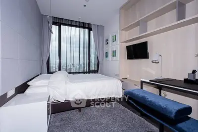 Modern bedroom with city view, featuring sleek design and ample natural light.