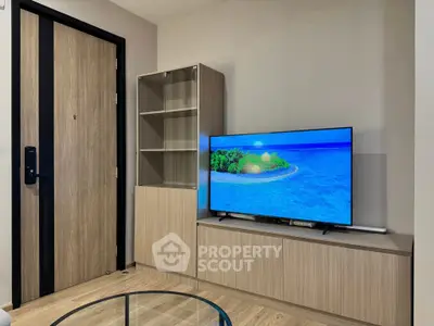 Modern living room with sleek wooden furniture and flat-screen TV, perfect for cozy evenings.