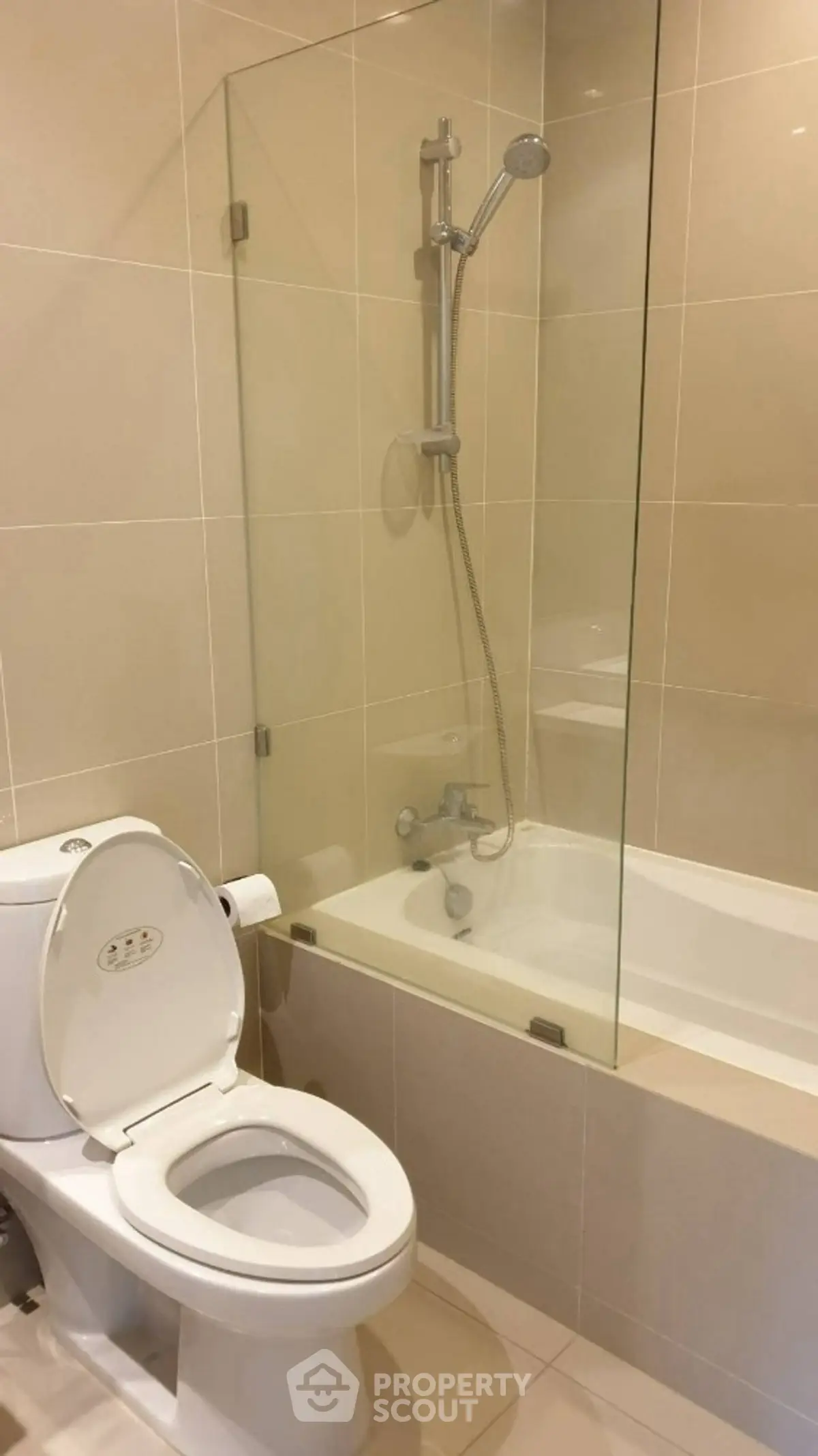 Modern bathroom with bathtub and shower in sleek tiled design.