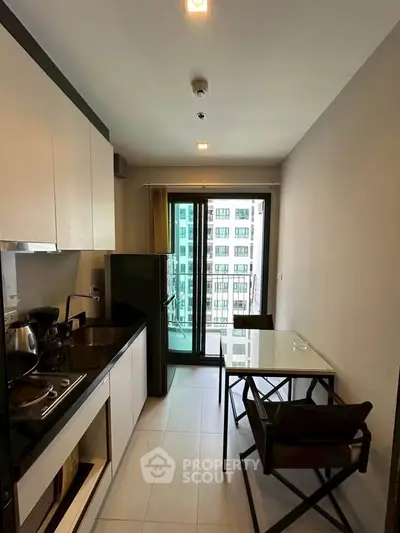 Modern kitchen with balcony view in high-rise apartment