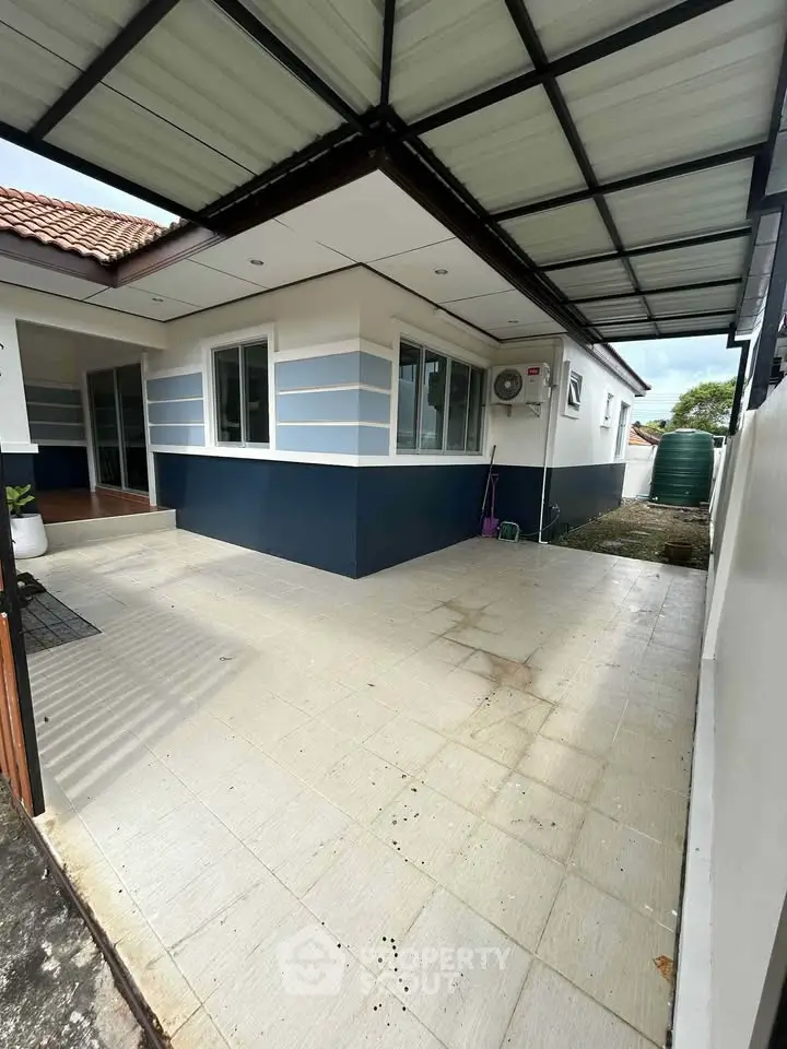 Charming single-story home with spacious covered patio and modern exterior design.