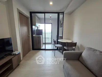 Modern living room with open kitchen and balcony view