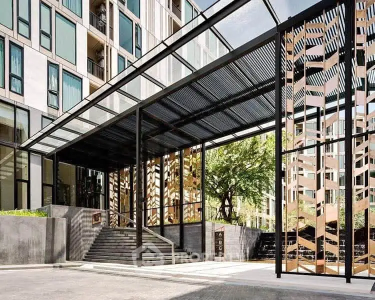 Modern building entrance with stylish metal and glass design, showcasing urban architecture.
