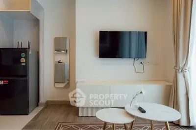 Modern living room with wall-mounted TV and sleek furniture