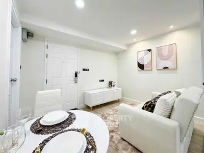 Modern living room with stylish decor and dining area in a cozy apartment.