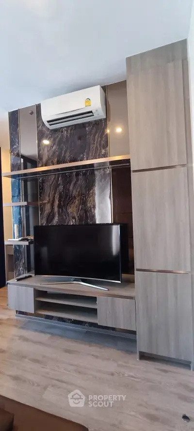 Modern living room with sleek TV unit and air conditioning