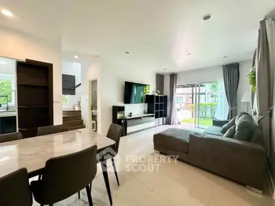 Spacious modern living room with garden view and elegant dining area