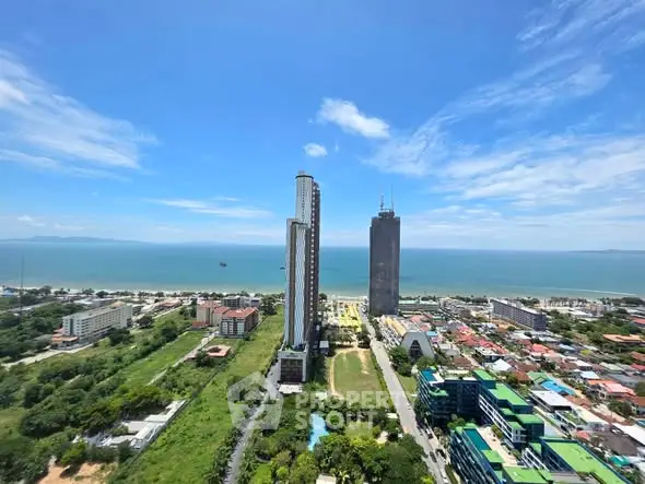 Stunning aerial view of beachfront high-rise buildings with ocean backdrop, perfect for luxury real estate investment.