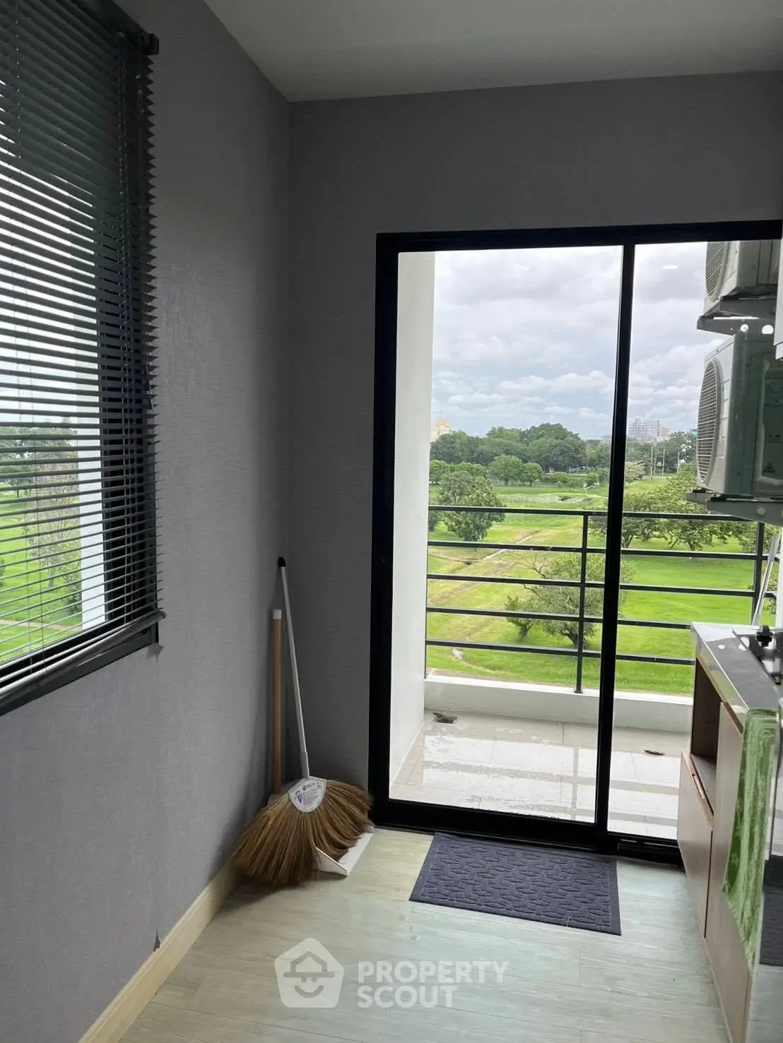 Charming balcony with lush green view, perfect for relaxation and enjoying nature's beauty.