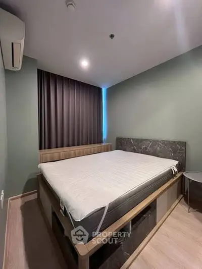 Modern bedroom with stylish bed and ambient lighting in a contemporary apartment.