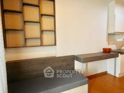 Modern minimalist interior with sleek wooden furniture and open kitchen layout