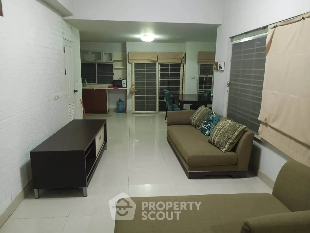 Spacious living room with modern furniture and open layout, perfect for family gatherings.