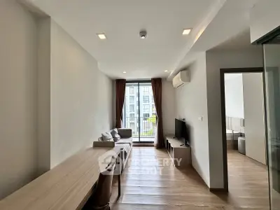 Modern living room with wooden flooring and natural light in a stylish apartment
