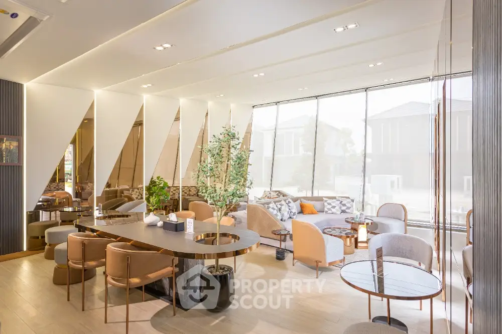 Luxurious modern living room with elegant furniture and large windows offering natural light.