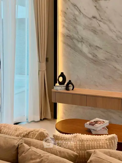 Luxurious living room with elegant marble wall and modern decor