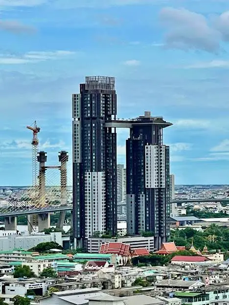 Stunning high-rise building with modern architecture and panoramic city views, perfect for urban living.
