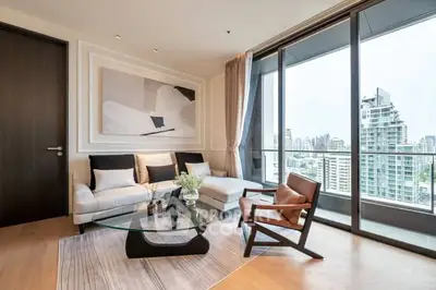 Luxurious living room with modern decor and stunning city view from large windows.