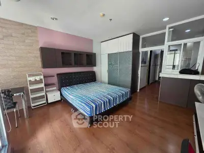 Spacious modern bedroom with stylish decor and wooden flooring