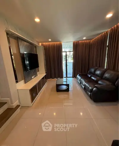 Spacious living room with modern decor and large windows for natural light.
