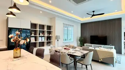 Modern open-plan living room with elegant dining area and stylish decor