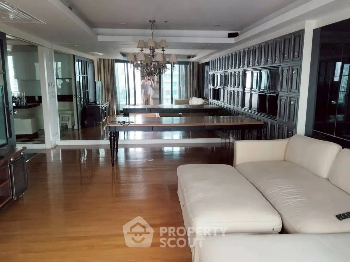 Spacious living room with elegant chandelier and large windows