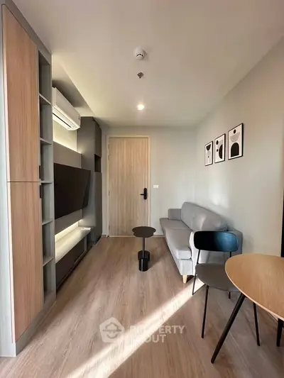 Modern living room with sleek furniture and stylish decor in a cozy apartment setting.