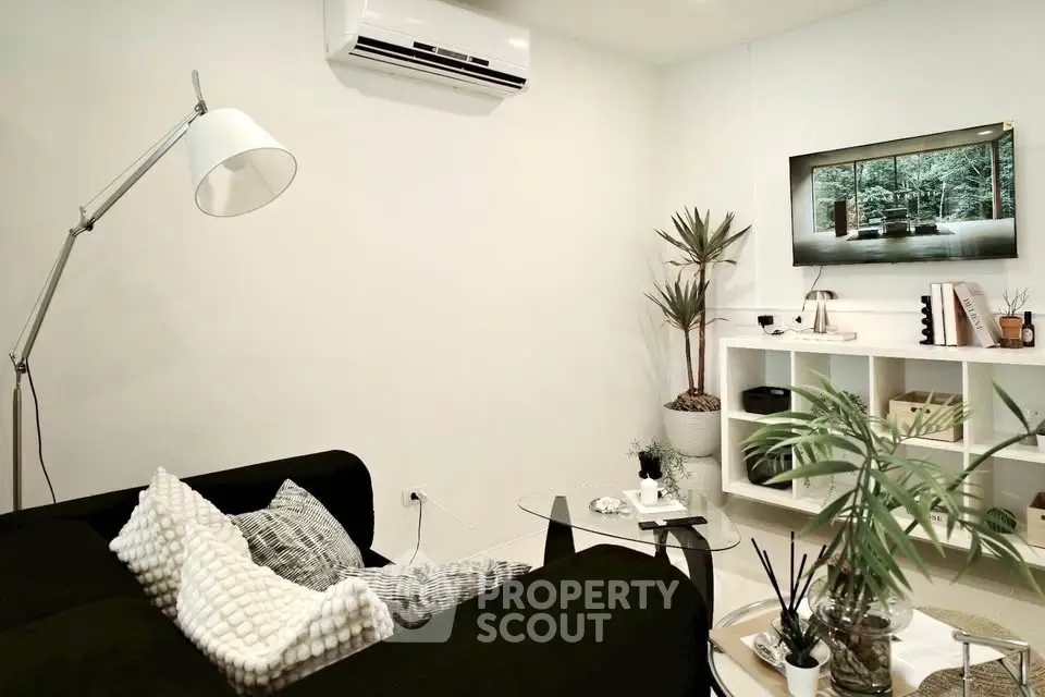 Modern living room with sleek black sofa and stylish decor