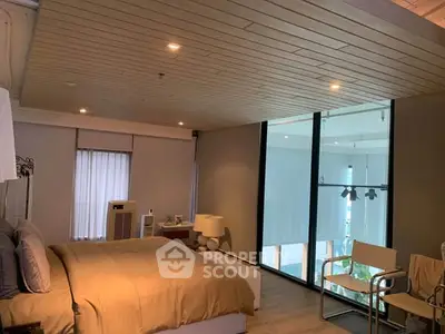 Spacious modern bedroom with large windows and stylish decor