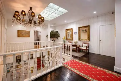 Elegant interior with chandelier and red carpet in a stylish hallway