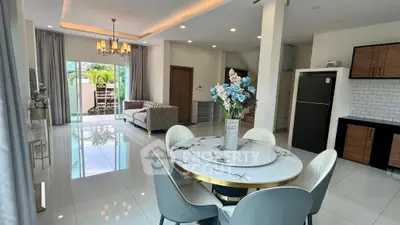 Elegant open-plan living and dining area with modern decor and natural light.