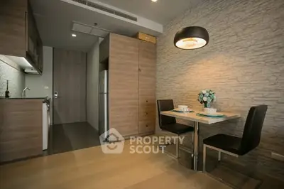 Modern kitchen with stylish dining area and contemporary lighting