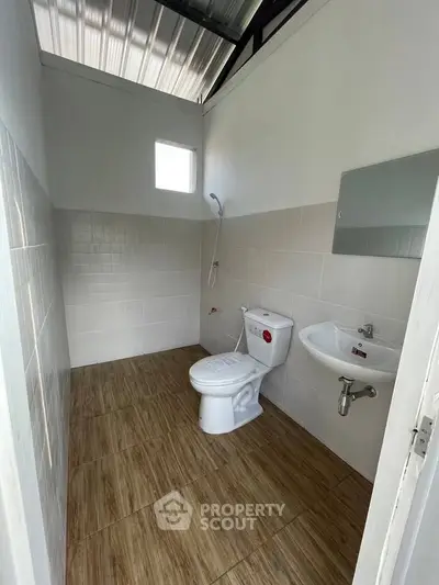 Compact bathroom with modern fixtures and natural light